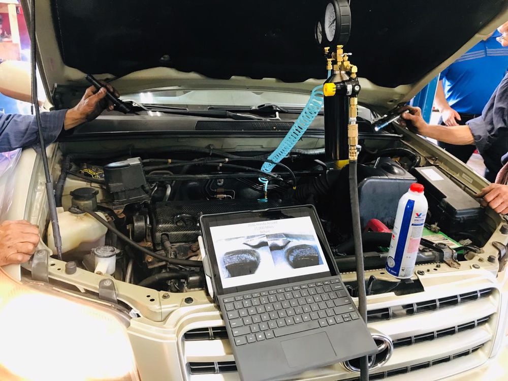 Close-up of computerized diagnostic equipment on engine bay